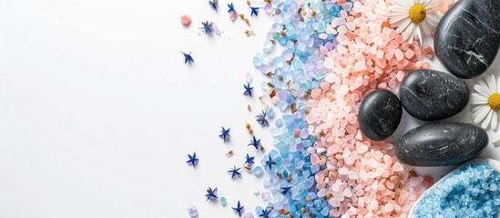 Poster - Spa items like blue and pink sea salt sea stones and herbal pouches for massage set against a clean white backdrop perfect for a copy space image