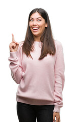 Canvas Print - Young beautiful hispanic woman wearing a sweater pointing finger up with successful idea. Exited and happy. Number one.