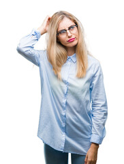 Poster - Young beautiful blonde business woman wearing glasses over isolated background confuse and wonder about question. Uncertain with doubt, thinking with hand on head. Pensive concept.