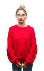 Sticker - Young beautiful blonde woman wearing red sweater and glasses over isolated background skeptic and nervous, frowning upset because of problem. Negative person.