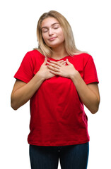 Poster - Young caucasian woman over isolated background smiling with hands on chest with closed eyes and grateful gesture on face. Health concept.