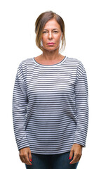 Wall Mural - middle age senior hispanic woman over isolated background with serious expression on face. simple an