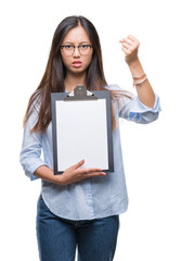 Poster - Young asian business woman holding clipboard over isolated background annoyed and frustrated shouting with anger, crazy and yelling with raised hand, anger concept