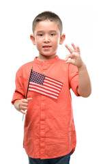 Canvas Print - Dark haired little child holding United States flag doing ok sign with fingers, excellent symbol