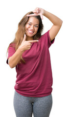 Canvas Print - Young beautiful brunette woman over isolated background smiling making frame with hands and fingers with happy face. Creativity and photography concept.