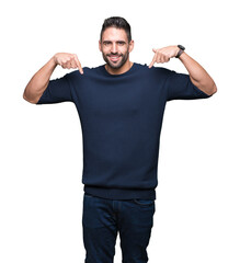 Canvas Print - Young handsome man wearing sweater over isolated background looking confident with smile on face, pointing oneself with fingers proud and happy.