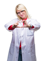 Wall Mural - Young beautiful blonde professional woman wearing white coat over isolated background smiling in love showing heart symbol and shape with hands. Romantic concept.