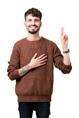 Young handsome man wearing winter sweater over isolated background Swearing with hand on chest and fingers, making a loyalty promise oath