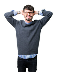 Wall Mural - Young handsome smart man wearing glasses over isolated background Relaxing and stretching with arms and hands behind head and neck, smiling happy