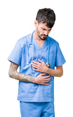 Poster - Young handsome nurse man wearing surgeon uniform over isolated background with hand on stomach because nausea, painful disease feeling unwell. Ache concept.