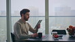 © stockbusters - Blurred man reading tablet sitting panoramic kitchen table at morning closeup