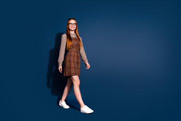 Canvas Print - Full length photo of dreamy excited lady dressed plaid outfit walking emtpy space isolated dark blue color background