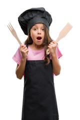 Poster - Brunette hispanic girl wearing cook uniform scared in shock with a surprise face, afraid and excited with fear expression