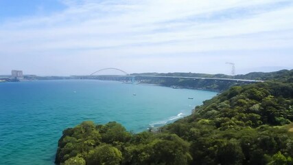 Wall Mural - Serene coastal landscape with lush greenery clear blue water