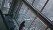 © stockbusters - Domestic woman thinking future looking panoramic window in flat high angle shot