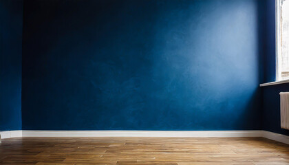 Dark blue wall in an empty room with a wooden floor