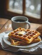 © Alexander Chaykin - A plate of waffles served with a warm cup of coffee, perfect for breakfast or brunch