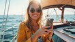 © Usman - Luxury travel on the yacht Young happy woman using smartphone on boat deck sailing the sea Yachting and technology
