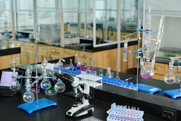 Aufkleber - Various glassware, desktop computer and microscope standing on workplace of clinician or chemist in spacious modern laboratory