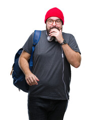 Poster - Young hipster man wearing red wool cap and backpack over isolated background looking stressed and nervous with hands on mouth biting nails. Anxiety problem.