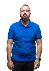 Sticker - Young caucasian hipster man wearing blue shirt over isolated background with serious expression on face. Simple and natural looking at the camera.