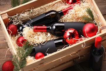 Poster - Wooden crate with bottles of wine, fir twigs and red Christmas balls on table