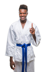 Sticker - Young african american man over isolated background wearing kimono showing and pointing up with finger number one while smiling confident and happy.