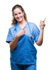 Poster - Young brunette doctor girl wearing nurse or surgeon uniform over isolated background smiling and looking at the camera pointing with two hands and fingers to the side.