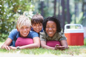 Wall Mural - We are ready to have fun. Shot of young boys lying on the grass.