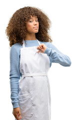 Sticker - African american shop owner woman wearing an apron proud, excited and arrogant, pointing with victory face