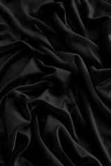 Aufkleber - Close-up view of black fabric with intricate design. Fabric appears wrinkled, folded. Beige background contrasts with dark fabric. For fashion, textile, design projects.