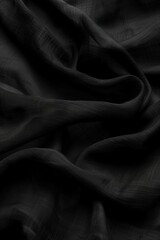 Poster - Close-up view of black fabric with subtle sheen. Fabric folded in half intricate texture. Gray background creates striking visual effect. Fabric texture perfect for design inspiration.