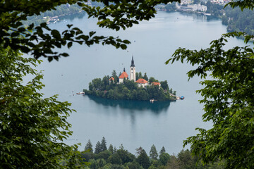 Wall Mural - Panoramic view from Lake Bled, beauty heritage in Slovenia. Island with church and castle in the background create a dream setting. View from Ojstrica and Mala Osojnica with the heart-shaped bench.