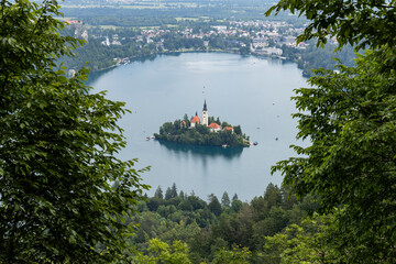 Wall Mural - Panoramic view from Lake Bled, beauty heritage in Slovenia. Island with church and castle in the background create a dream setting. View from Ojstrica and Mala Osojnica with the heart-shaped bench.