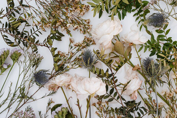 Wall Mural - Elegant Close-Up of White Rose Bouquet and Wildflowers on White Background. Floral Background for Weddings, Celebrations and Romantic Occasions