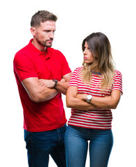 Sticker - Young couple in love over isolated background skeptic and nervous, disapproving expression on face with crossed arms. Negative person.