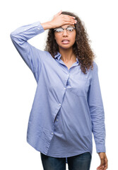 Poster - Beautiful young hispanic woman wearing glasses stressed with hand on head, shocked with shame and surprise face, angry and frustrated. Fear and upset for mistake.