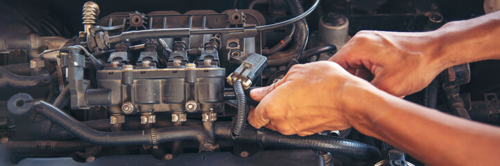 Wall Mural - Banner Man hands fixing Car machinery vehicle mechanical service. Mechanic man hands repairing car shop. panoramaopen vehicle hood checking up auto mobile. Car maintenance engineer with copy sapce.