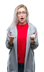 Sticker - Young blonde business woman wearing fashion jacket over isolated background afraid and shocked with surprise expression, fear and excited face.