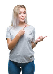 Canvas Print - Young blonde woman over isolated background smiling and looking at the camera pointing with two hands and fingers to the side.