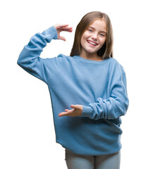 Wall Mural - Young beautiful girl wearing winter sweater over isolated background gesturing with hands showing big and large size sign, measure symbol. Smiling looking at the camera. Measuring concept.