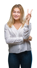 Poster - Young caucasian woman over isolated background smiling with happy face winking at the camera doing victory sign. Number two.