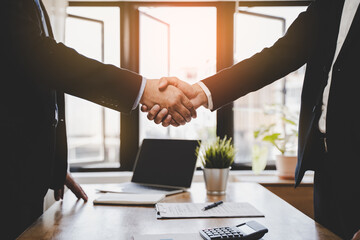 Wall Mural - close-up view hands of agent and client shaking hands after signed contract buy new apartment.