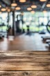 © miss irine - Gym interior has wooden floor, large windows, exercise equipment and table. Modern fitness studio with machines, free weights and treadmills. Suitable for product display and advertising.