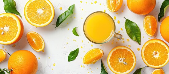 Poster - Create a vibrant image by displaying freshly squeezed orange juice in a glass surrounded by halved oranges and a juicer on a white background from a top view perspective with room for text or other e