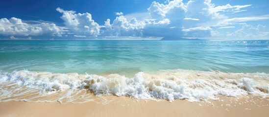 Canvas Print - Scenic beach with clear blue sea gentle waves and sky with clouds ideal for text or design represents a travel concept with copy space image