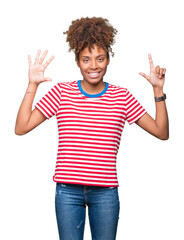 Wall Mural - Beautiful young african american woman over isolated background showing and pointing up with fingers number seven while smiling confident and happy.