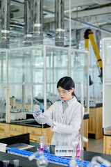 Aufkleber - Chinese female researcher in lab coat, protective eyeglasses and gloves carrying out chemical investigation while standing by workplace