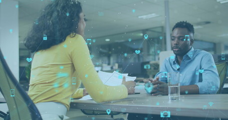 Wall Mural - Image of network of icons over diverse man and woman discussing and shaking hands at office