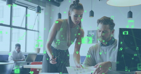 Poster - Image of network of digital icons over caucasian man and woman discussing at office